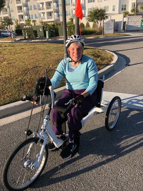 Donna R. Gore riding an adaptive bicycle